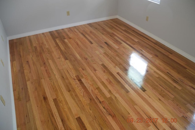 empty room with light hardwood / wood-style flooring