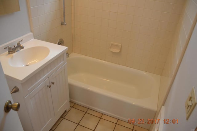 bathroom featuring vanity, tiled shower / bath, and tile patterned flooring