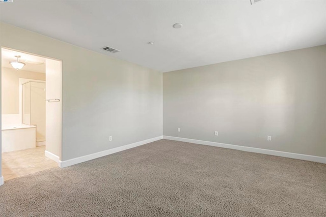 empty room with light colored carpet