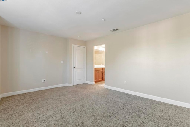 spare room with light colored carpet