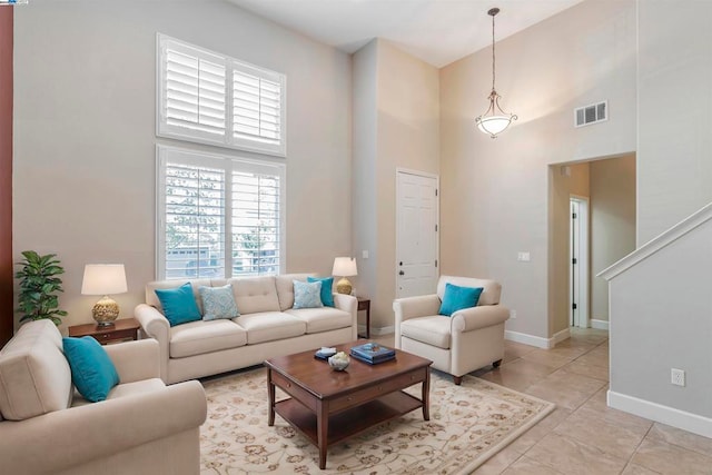 living room featuring light tile patterned floors and a high ceiling