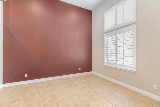 unfurnished room featuring light tile patterned floors