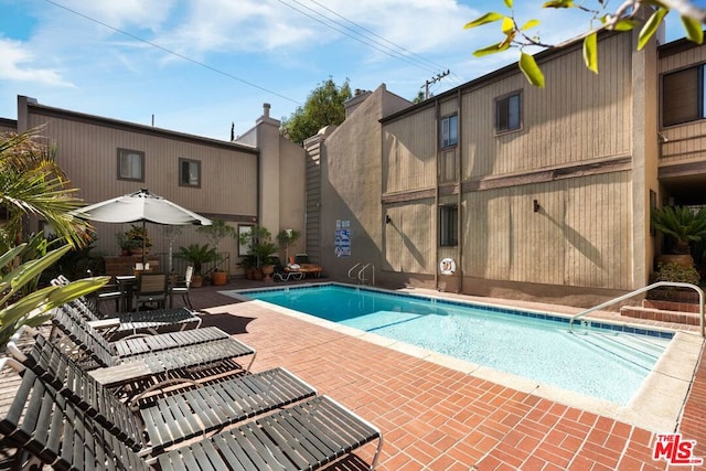 view of swimming pool featuring a patio