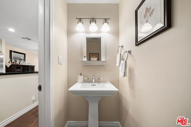 bathroom with hardwood / wood-style floors