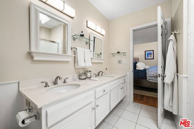 bathroom featuring tile patterned flooring and vanity