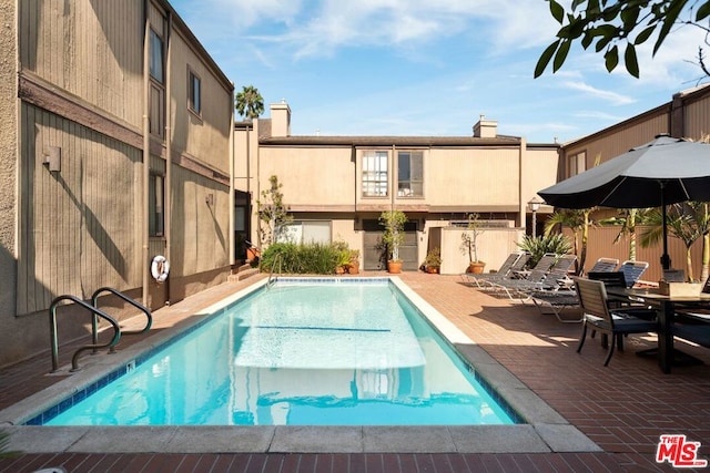 view of swimming pool with a patio area