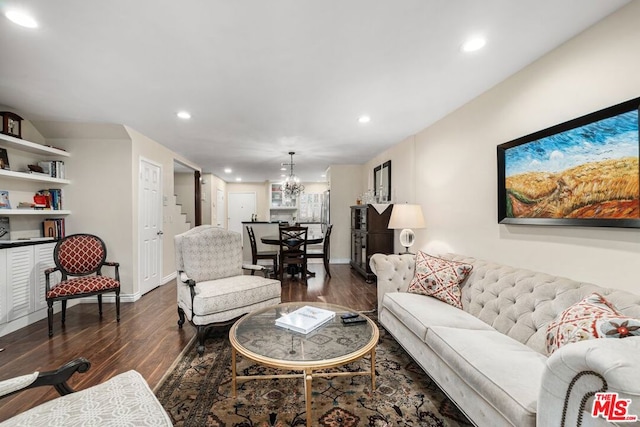 living room featuring dark hardwood / wood-style floors and an inviting chandelier