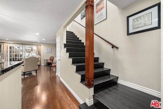 staircase with hardwood / wood-style flooring