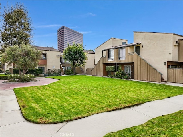 view of property's community with a lawn