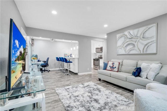 living room with hardwood / wood-style flooring and ceiling fan