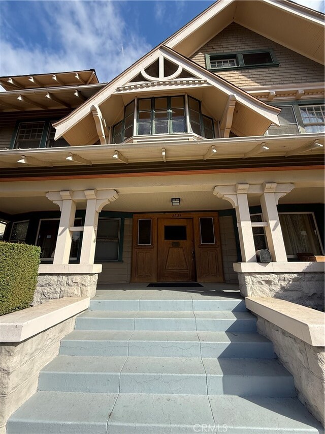 doorway to property featuring covered porch