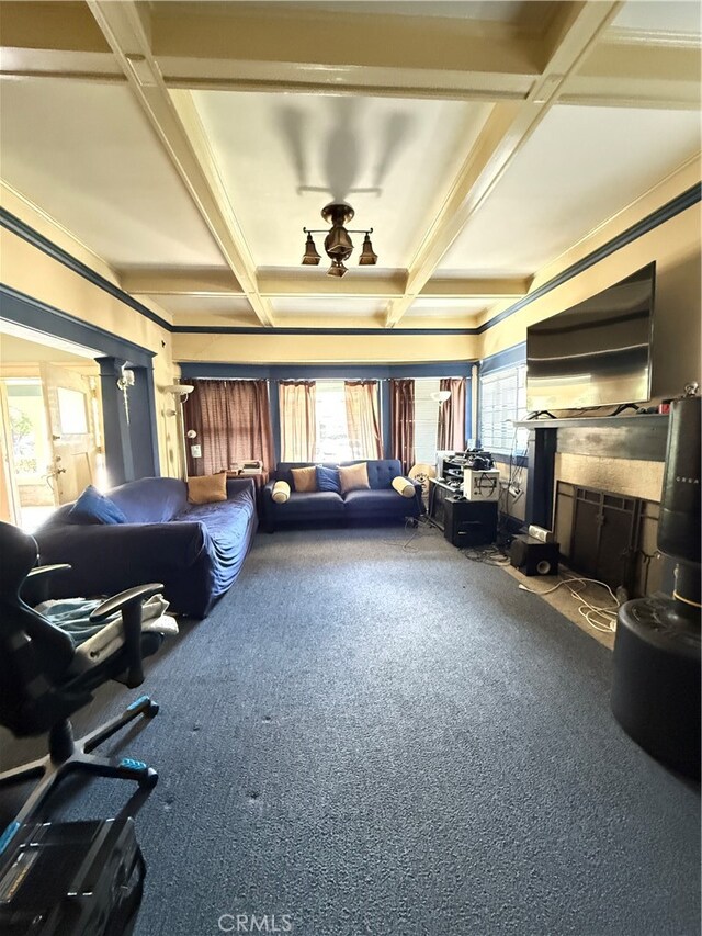 living room with coffered ceiling, a healthy amount of sunlight, and carpet