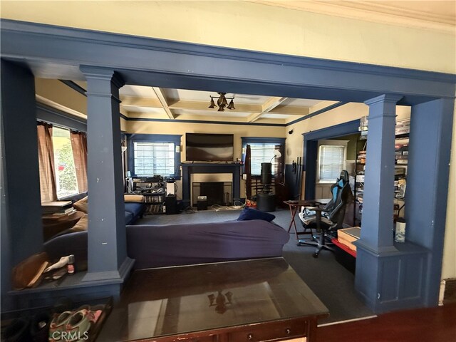 interior space with ornamental molding and coffered ceiling