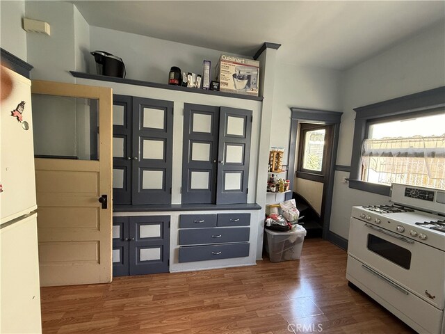 interior space featuring wood-type flooring and white appliances