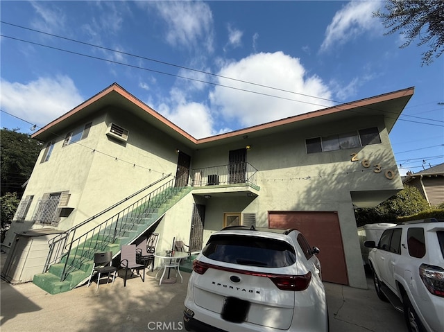 view of front of home featuring a garage and a balcony