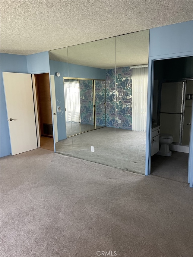 37800 Rudall Ave, Palmdale, CA 93550 - unfurnished bedroom with carpet, a textured ceiling, and ensuite bathroom