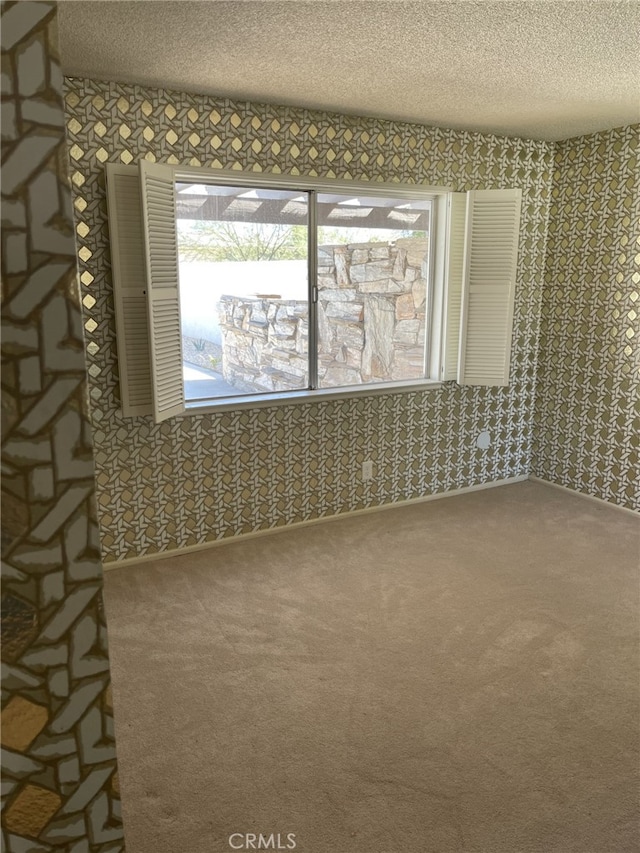 37800 Rudall Ave, Palmdale, CA 93550 - empty room with a textured ceiling, carpet, and wallpapered walls