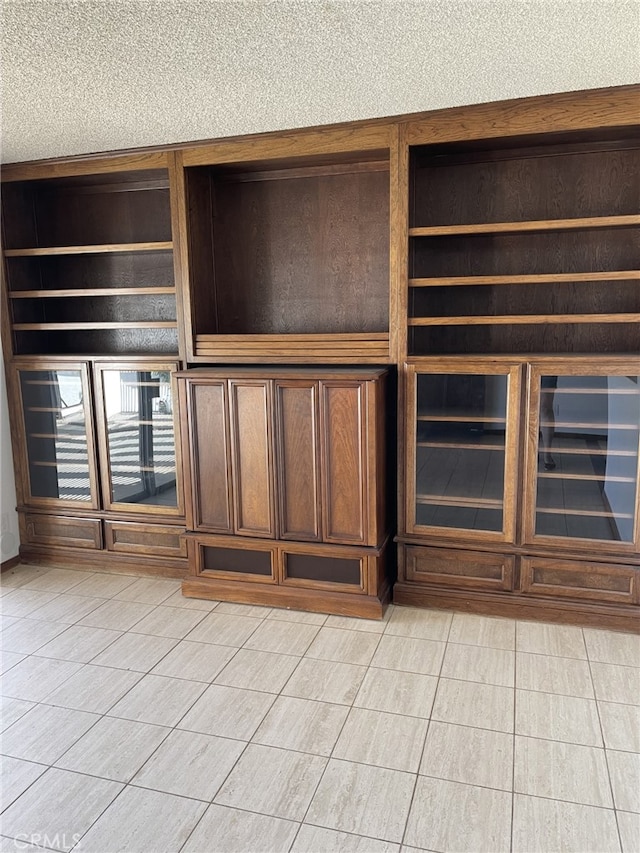 37800 Rudall Ave, Palmdale, CA 93550 - unfurnished living room featuring light tile patterned floors and a textured ceiling