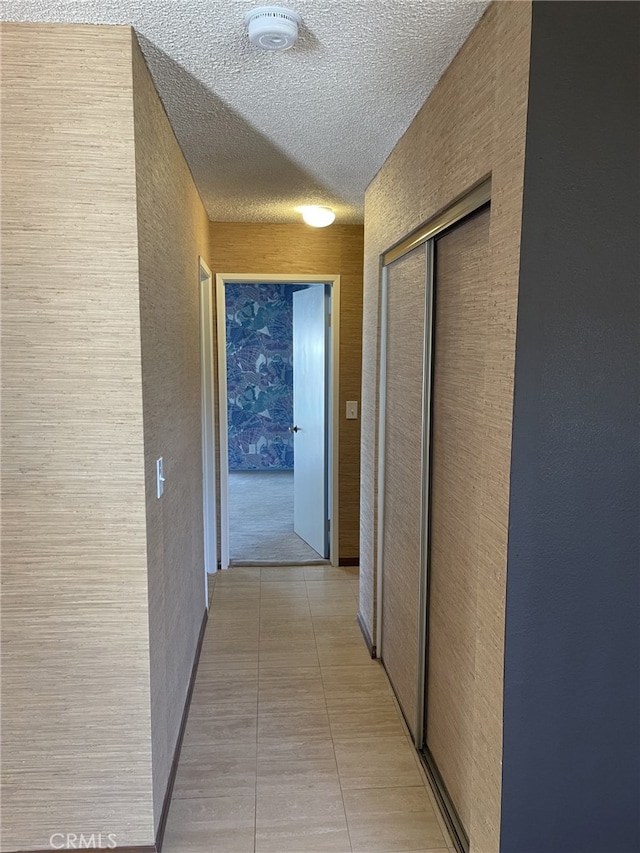 37800 Rudall Ave, Palmdale, CA 93550 - corridor with a textured ceiling, a textured wall, and light tile patterned floors