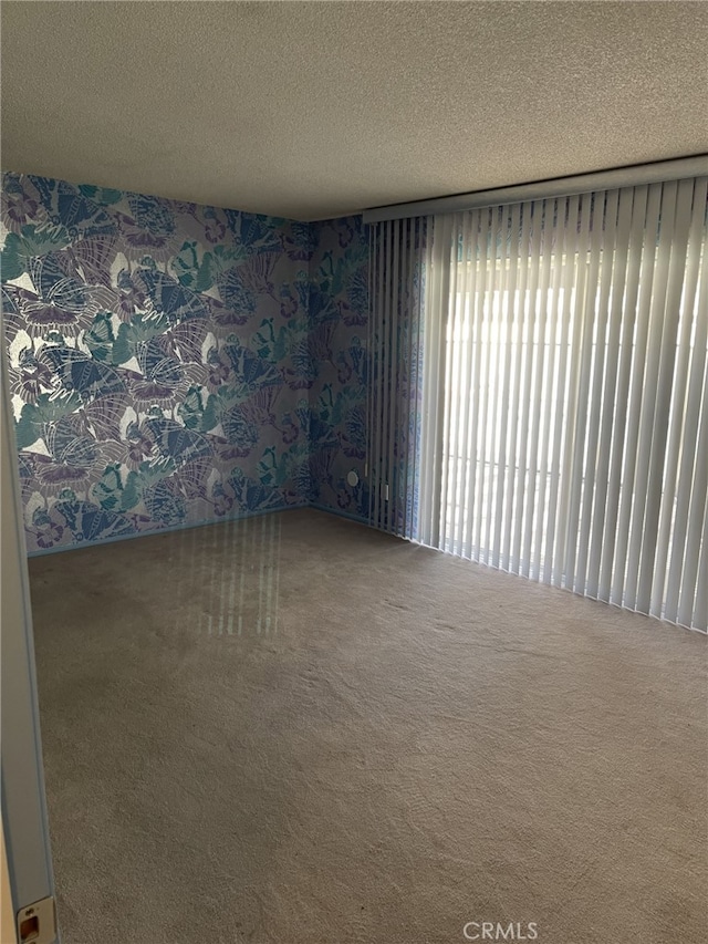 37800 Rudall Ave, Palmdale, CA 93550 - unfurnished room with carpet flooring, a textured ceiling, and wallpapered walls