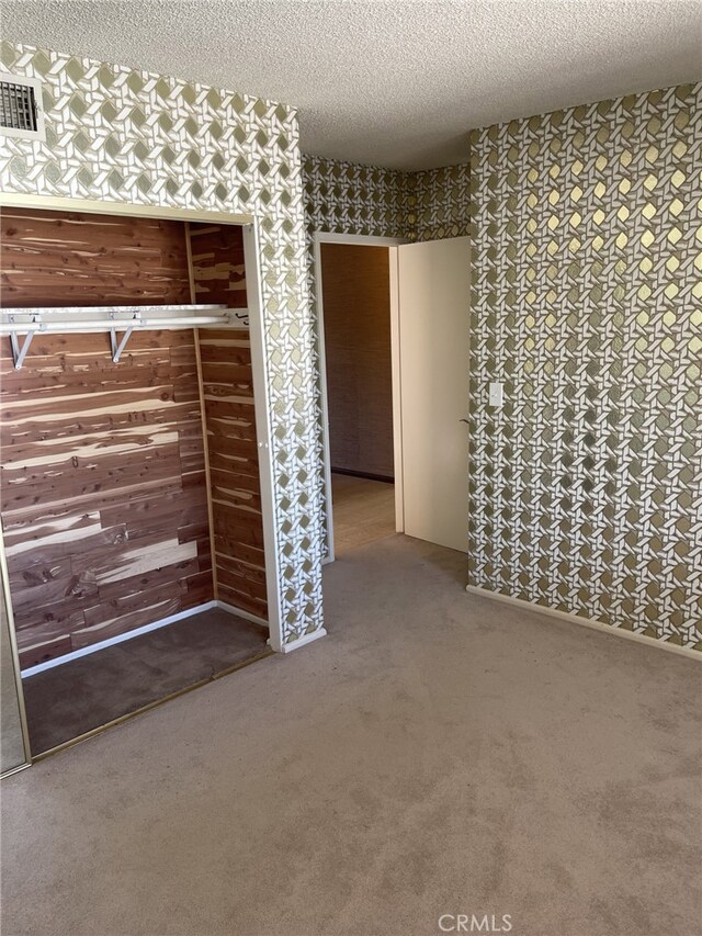 37800 Rudall Ave, Palmdale, CA 93550 - unfurnished bedroom with a textured ceiling, carpet floors, and wallpapered walls