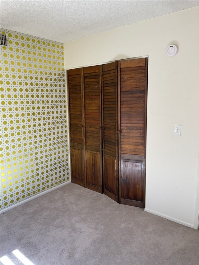 37800 Rudall Ave, Palmdale, CA 93550 - unfurnished bedroom featuring carpet, a closet, a textured ceiling, and baseboards