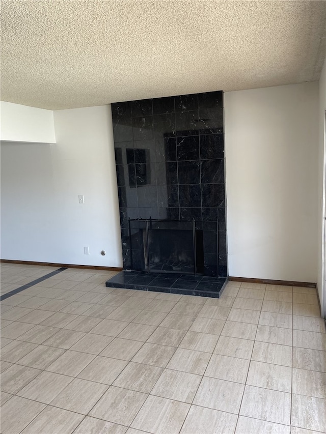 37800 Rudall Ave, Palmdale, CA 93550 - unfurnished living room featuring a textured ceiling, a fireplace, and baseboards
