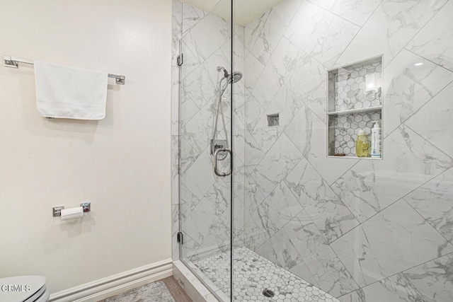 bathroom featuring toilet and an enclosed shower