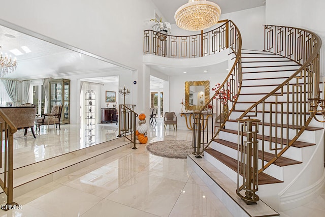 foyer featuring a notable chandelier and a high ceiling