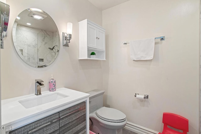 bathroom featuring vanity, a shower, and toilet