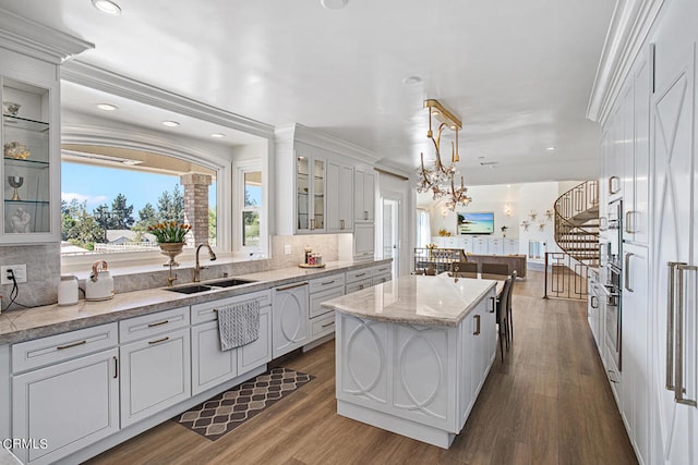 kitchen featuring white cabinetry, sink, a center island, and dark hardwood / wood-style floors