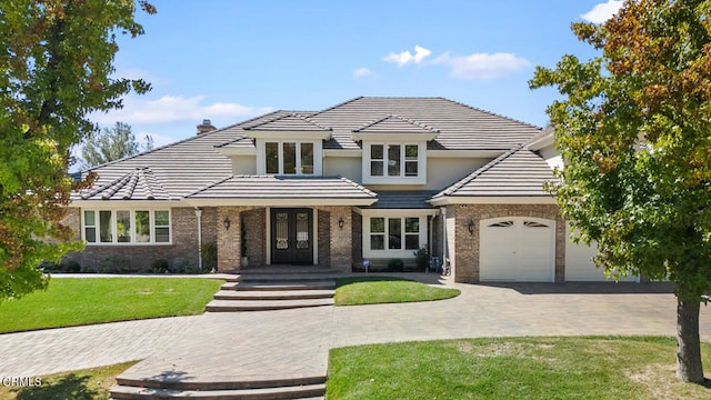 view of front of home with a front lawn and a garage