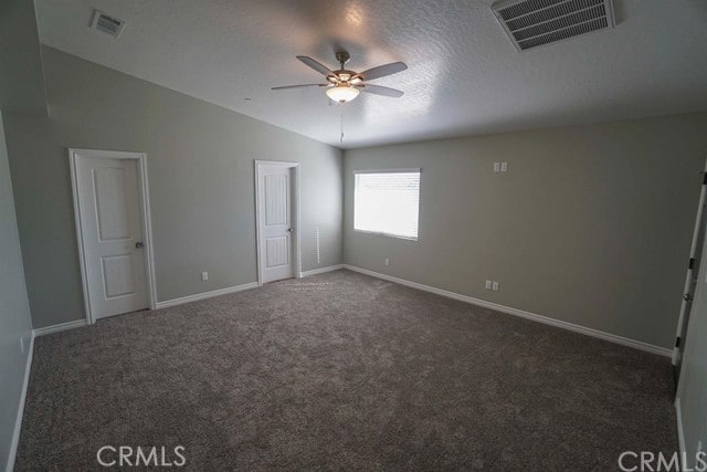 carpeted empty room featuring lofted ceiling and ceiling fan