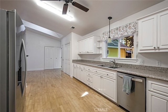 14331 Troy Way, Magalia, CA 95954 - kitchen featuring a sink, visible vents, white cabinets, lofted ceiling with skylight, and appliances with stainless steel finishes