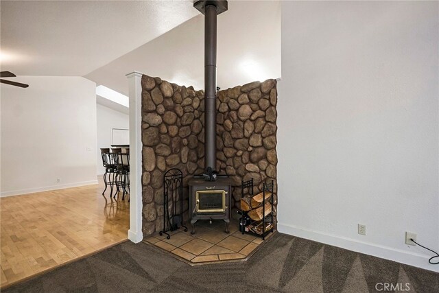 14331 Troy Way, Magalia, CA 95954 - details featuring a wood stove, baseboards, and ceiling fan