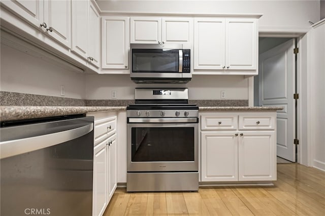 14331 Troy Way, Magalia, CA 95954 - kitchen featuring light wood-type flooring, white cabinets, and appliances with stainless steel finishes