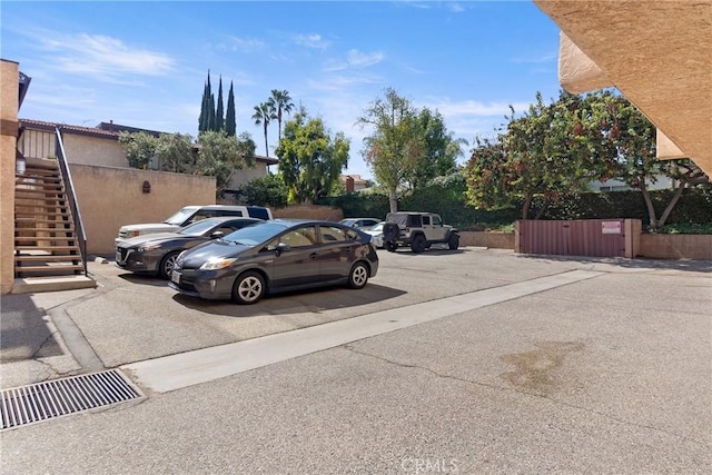 uncovered parking lot featuring stairs