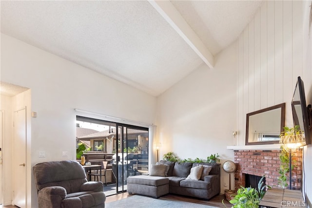 living room featuring beamed ceiling, hardwood / wood-style floors, a brick fireplace, high vaulted ceiling, and wood walls