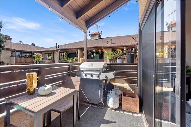 view of patio with grilling area and a balcony