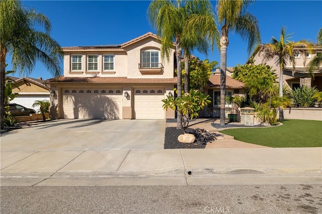 mediterranean / spanish-style house featuring a garage and a front lawn