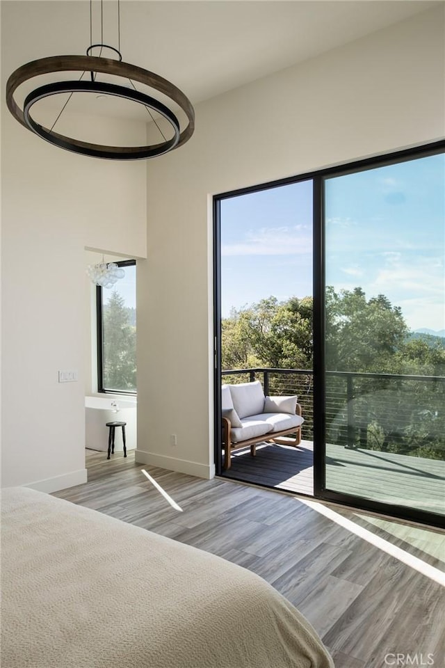 unfurnished bedroom featuring multiple windows and light wood-type flooring