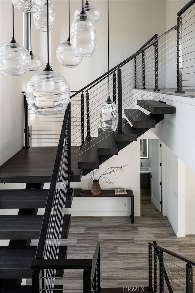 staircase with hardwood / wood-style floors