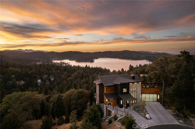 aerial view at dusk with a water view