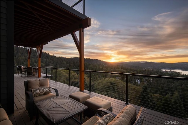 deck at dusk featuring a mountain view