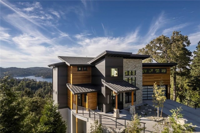 rear view of property featuring a water view