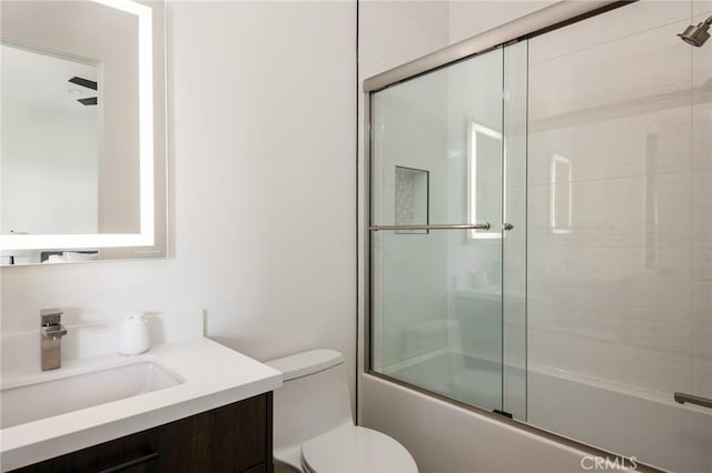 full bathroom with vanity, toilet, and shower / bath combination with glass door