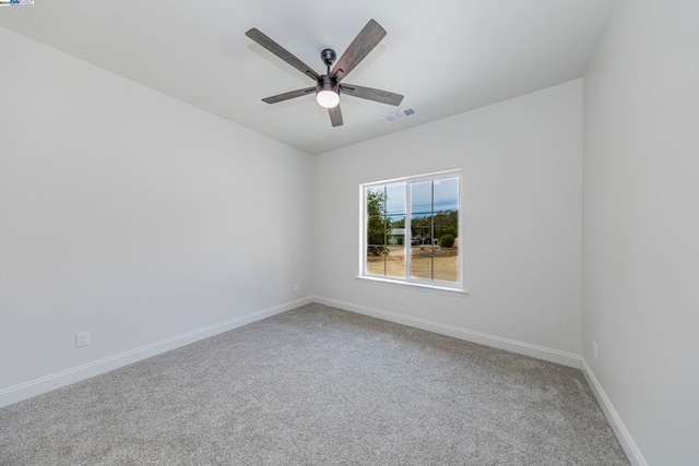 carpeted empty room featuring ceiling fan