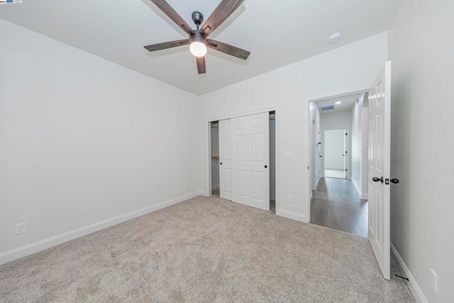 unfurnished bedroom featuring a closet, ceiling fan, and carpet floors