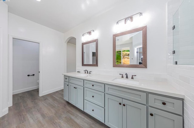 bathroom with vanity, hardwood / wood-style flooring, toilet, and walk in shower