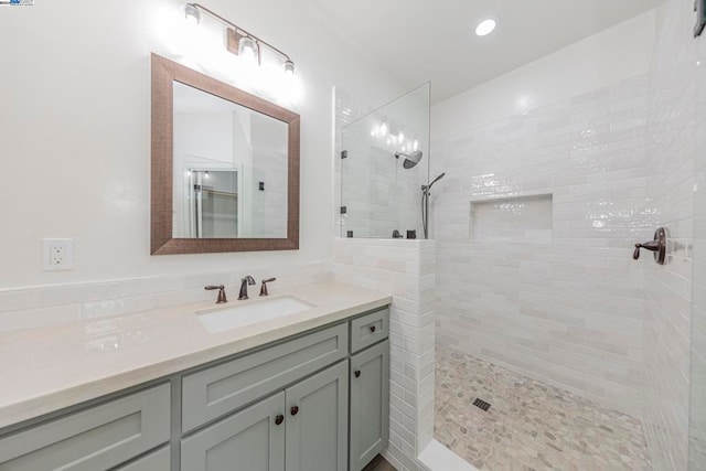 bathroom featuring vanity and tiled shower